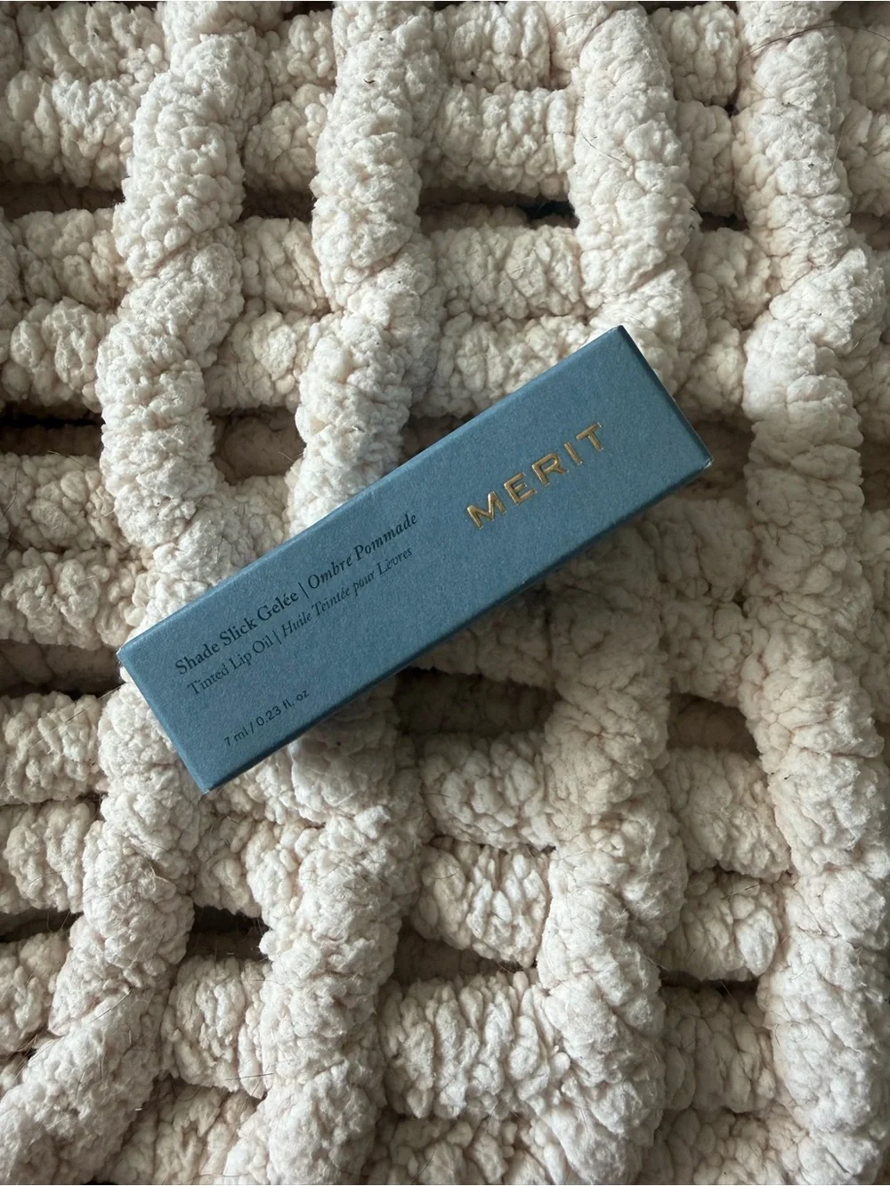 Merit tinted lip oil in Jete